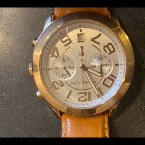 Gold plated MK watch with tan leather band.